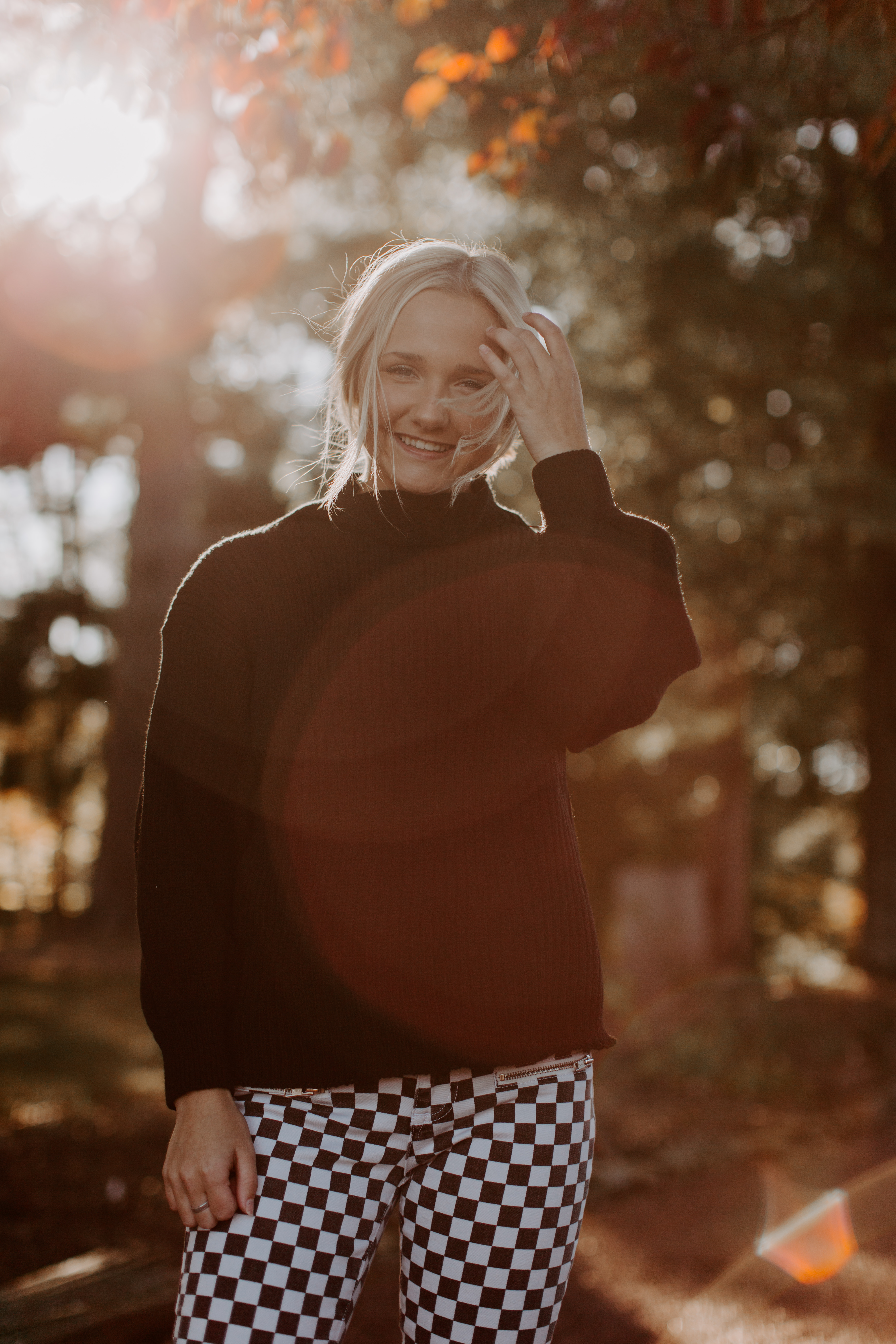 Ashley W. free people senior pictures black sweater checkered pants lifestyle city candid model pose wedding elopement blonde hair outfit overall white preset